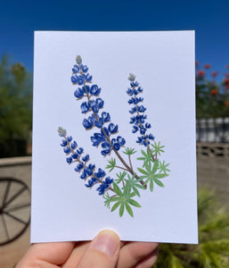 Greeting card with a watercolor Palmer's lupine on the front, showing purple/blue flowers and green leaves