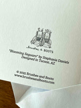 Load image into Gallery viewer, Back of card with the text &quot;Blooming Saguaro&quot; by Stephanie Daniels, Designed in Tucson, AZ